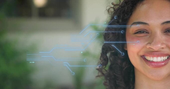 Adult woman receiving sliding blue circuit graphics scanning face and smiling in technology demo