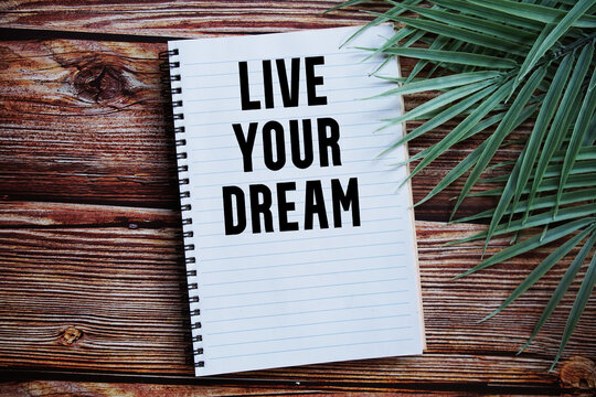 Naklejki Live Your Dream Motivational and Inspirational quotes on wooen background