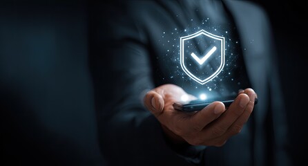 Businessman holds phone, security shield graphic