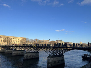Fototapeta premium Banks of the Seine river, Louvre museum and bridge in Paris, France