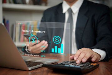 Property investment ROI , Investor uses calculator and laptop in office to analyze rental finance and realty data for growth, boosting analytics and value . concept financial strategy.