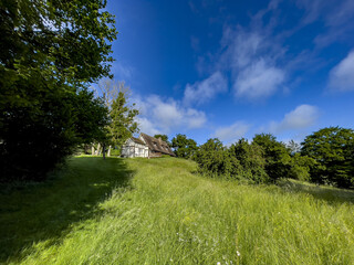 Obraz premium House and garden in Le Mesnil en Ouche, Eure, France