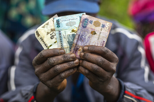 Microfinance borrower holding bank notes in a village near Huye, Southern province, Rwanda