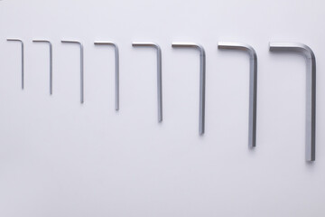 A set of hex keys in various sizes, arranged on a light background.