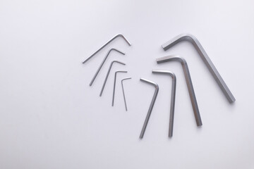 A set of hex keys in various sizes, arranged on a light background.