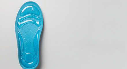 Orthopedic shoe inserts featuring vibrant blue gel cushioning on a light background