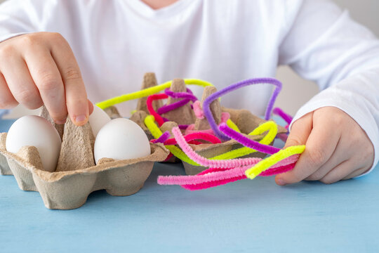 Child making decoration for Easter holiday.
