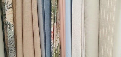 Curtains assortment in the home decor store. New high-quality curtains goods. Fabric store. Interior design. Sale and purchase of curtains and drapes. Curtains assortment. Fabrics of different colors