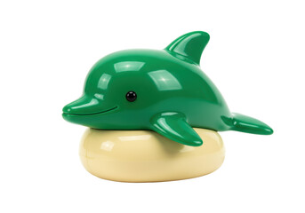 Isolated green plastic dolphin on yellow cushion toy, sea animal, happy, cheerful kid play