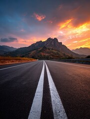 Scenic highway at sunrise, leading to mountains