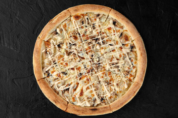 Delicious pizza with mushrooms and cheese resting on black surface