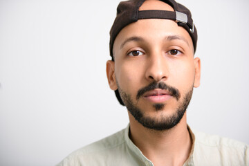 Fototapeta premium young islamic arab man against white studio wall