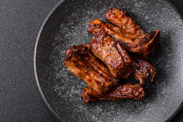 Grilled beef or pork ribs, meat cooked on a barbecue with salt and pepper. Grilled ribs