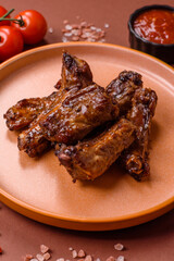 Grilled beef or pork ribs, meat cooked on a barbecue with salt and pepper. Grilled ribs