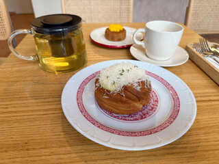 Shepherd's pie with grated cheese served on patterned plate with tea. Dining lifestyle, bakery culture and gastronomy with refreshment, leisure and culinary indulgence.