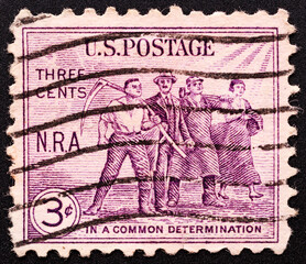 UNITED STATES OF AMERICA - CIRCA 1940. stamp printed in the United States devoted in common determination shows four men, circa 1940