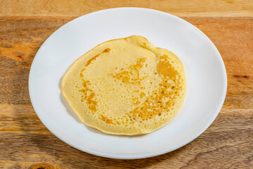 Pancake on ceramic plate for Butter Week.