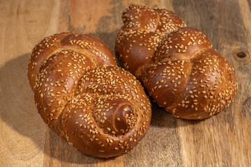 Challah for Jewish holiday Shabbat on wooden background.
