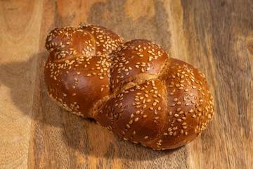 Challah for Shabbat on wooden background.
