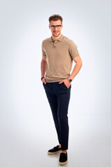 Fototapeta premium Studio portrait of confident young man standing against isolated background