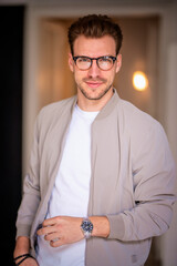 Headshot of a young man looking at camera and smiling