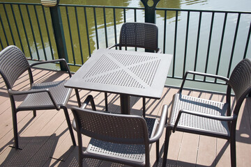 A wooden deck with a table and chairs