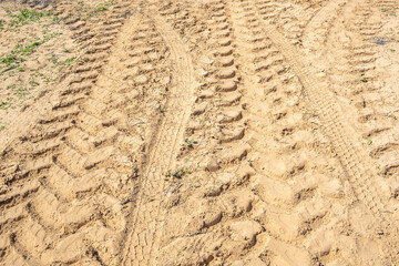 Tractor marks on the ground in desert.