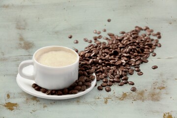 Coffee cup and beans on  desk background