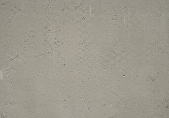 Close up of a textured concrete surface with subtle imperfections.
