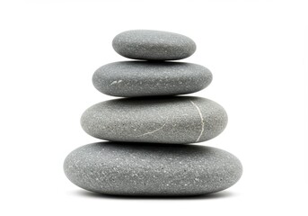 Fototapeta premium Stack of smooth grey stones balanced on a white background.