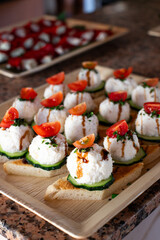 Tapas appetizer made from fish mousse, shaped into a ball and topped with a small slice of tomato