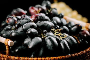Freshly harvested ripe grapes in a woven basket ready for enjoyment and tasting