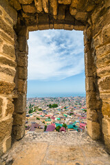 View of the old city of Derbent on the Caspian Sea coast through the window of the old fortress wall. Dagestan