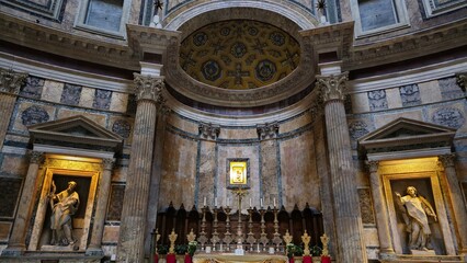 Rome, Italy - 10 January 2025. The Pantheon's main altar with flanking saint statues, gold-rimmed...