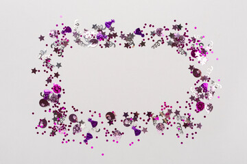 Party pink confetti on color background, top view