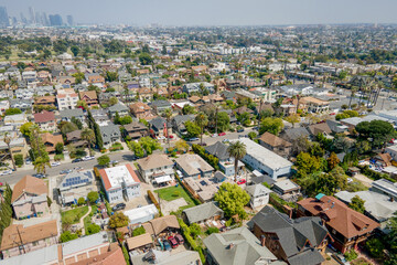 Obraz premium Los Angeles, LA County, CA, California, April 19, 2024: Aerial Drone City View toward LA Downtown, Koreatown, Venice Blvd, Western Ave with Homes, Houses, Apartments, Streets and 10 Freeway 