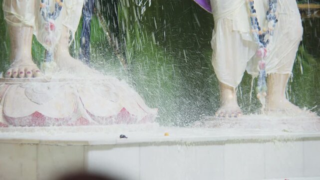 Milk flowing over the lotus feet of Sri Chaitanya Mahaprabhu and Sri Gadadhara Pandit deities