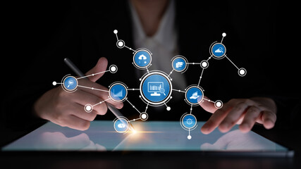 A business person interacts with a digital network displayed on a tablet, illustrating the connection between technology, data, and innovative strategies for success. Tessel