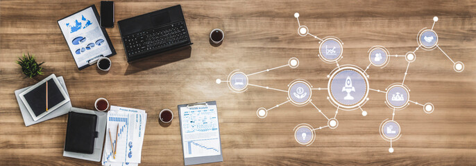 A modern workspace showcasing innovative tools and digital interfaces on a wooden table. Ideal for themes of productivity, communication, and business growth. Tessel