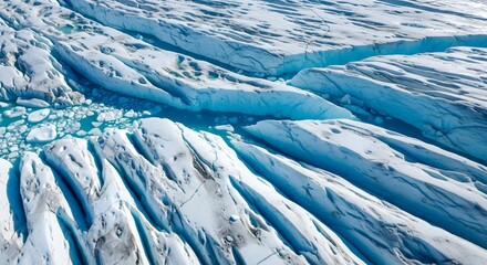 Aerial view of a glacier's crevasses and ice formations, showcasing the intricate patterns of glacial movement.