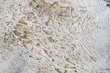 Pamukkale calcium terrace close up with clear water. Travertine mineral formation texture from Turkey hot spring. Natural background.
