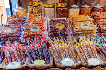Colorful sweet nut stalls at a market in Cadiz, Andalusia, Spain, September 2025.