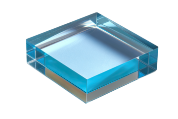 Transparent square block, likely glass, with inner layers.  Clear,  cuboid shape,  partially filled with light-blue liquid or gel.  Small,  transparent,  square-gridded supports