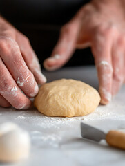 Obraz premium Dough preparation: Hands shaping dough on a floured surface. Homemade baking concept. Culinary arts in action. Flour dust on skin.