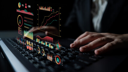 A business professional interacts with dynamic holographic data visualizations on a laptop, showcasing various graphs and charts in a sleek dark office space. Impute