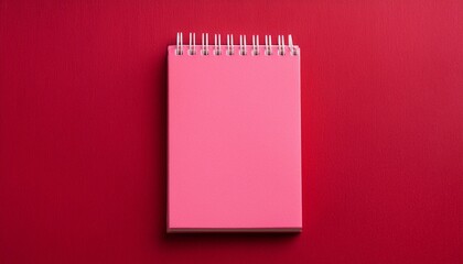 pink notepad on a red background