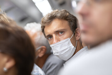 man wearing a medical mask in public transport to avoid the flu and respiratory diseases