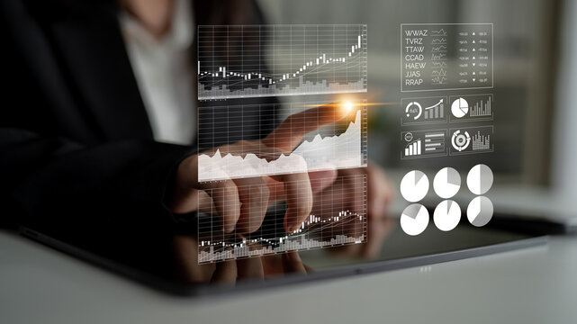 A businessman uses a tablet to interact with digital financial charts, analyzing stock market trends and gaining insights for strategic investment decisions. Impute