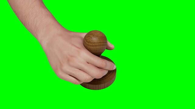 Wooden Hand stamp on green background with chroma key for easy composition, isolated on blue screen and alpha mask