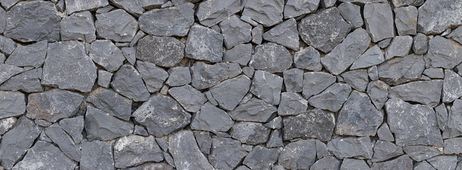 Panoramic texture of natural volcanic stone wall, Tenerife, Spain